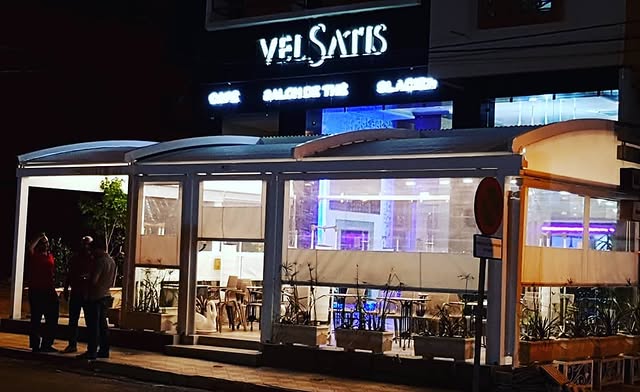 Velsatis facade illuminated at night with glass terrace