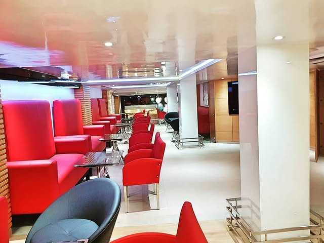 Lounge with red velvet armchairs