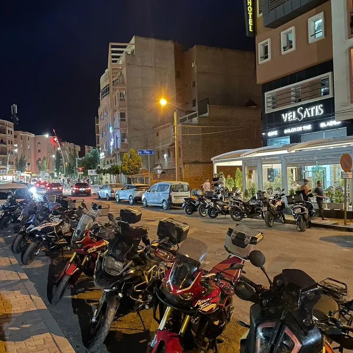 Velsatis on Mohamed V boulevard at night with motorcycles